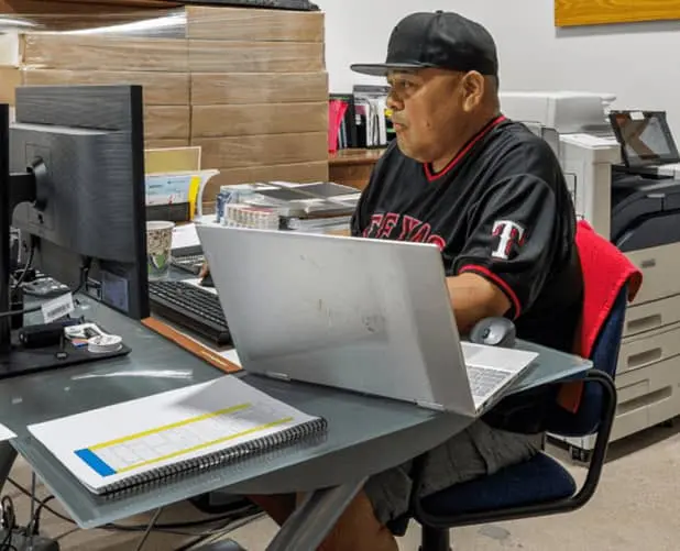 Tenant working at a desk with monitors inside a work-friendly WareSpace unit